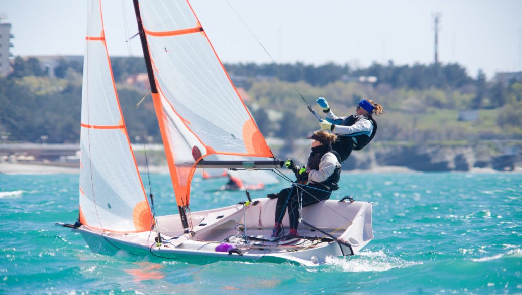 A team of two girls deftly managed to sail in the sea.